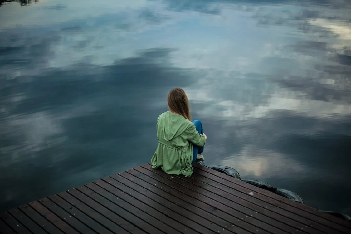 A person sitting on wooden planks