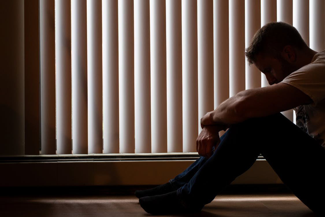 A person sitting in a depressive way 