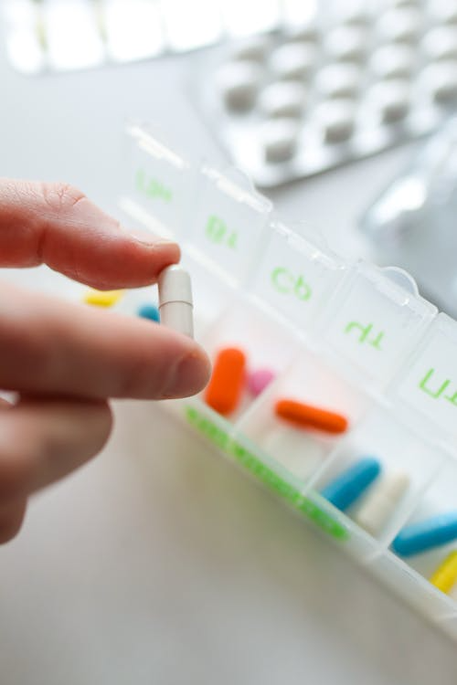 A person holding a pill
