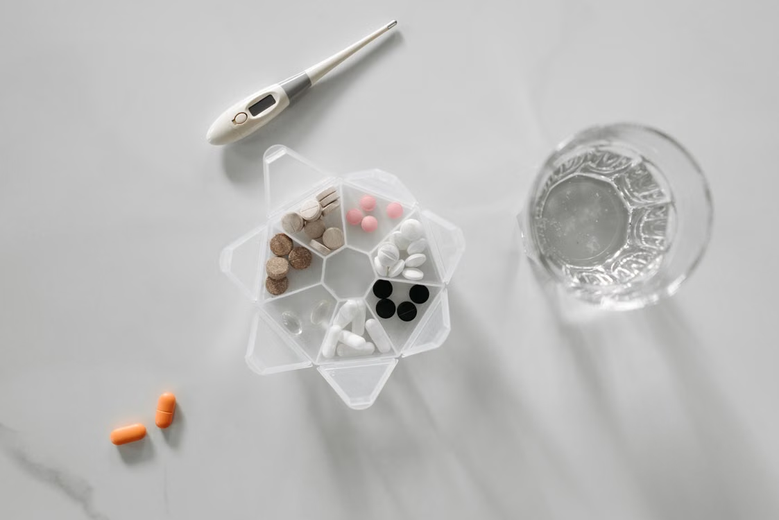 Medicines beside a glass of water
