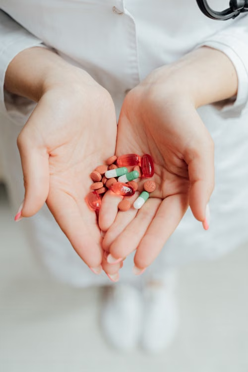 A person holding different medicines